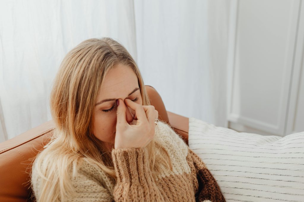 Woman holding her nose