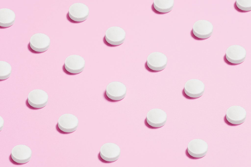 Medicine placed on a pink background